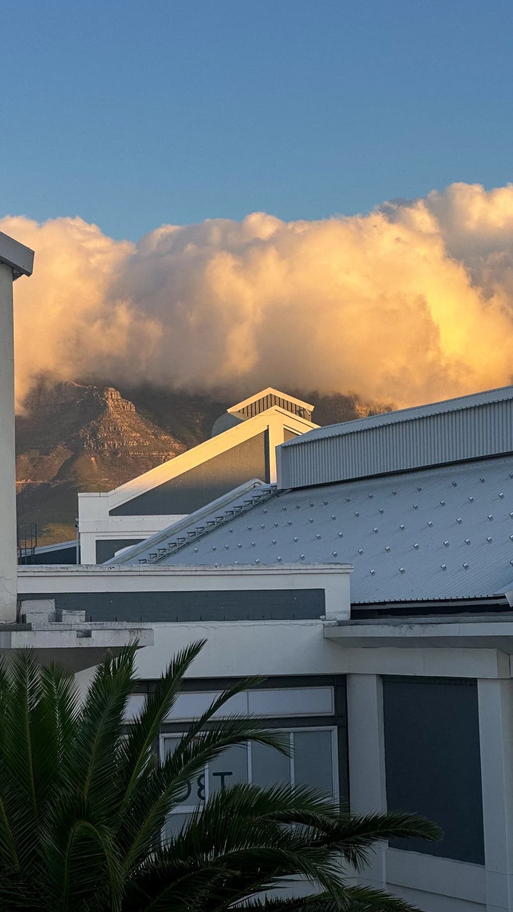 Golden clouds above a mountain and rooftops