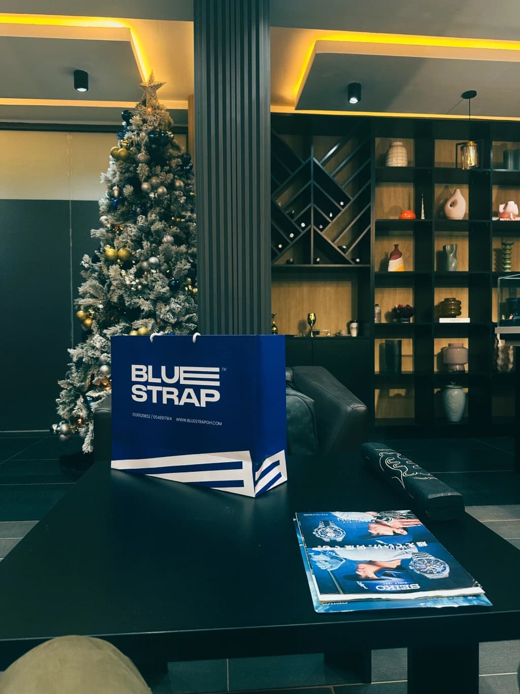A warmly lit café table with a Blue Strap display