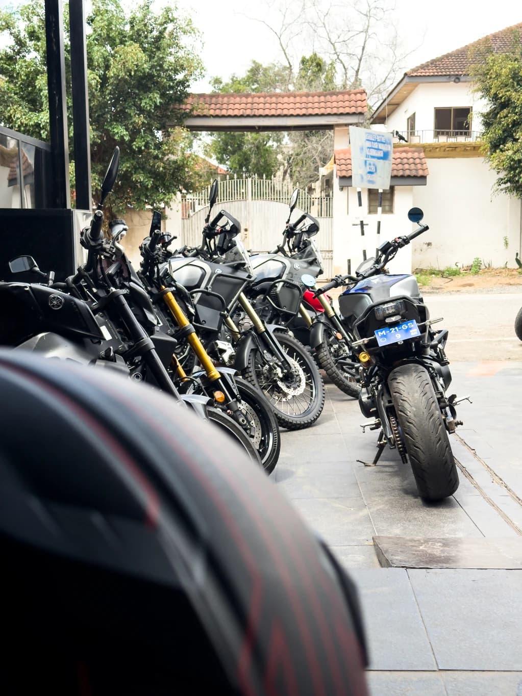 Motorcycles parked along a tree-lined street